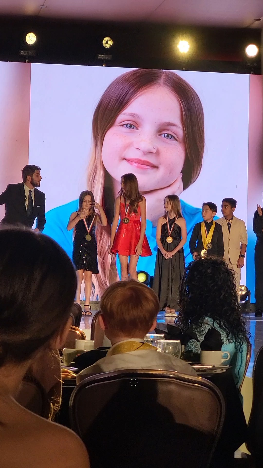 Caitlyn Helms receiving recognition on the iPOP stage